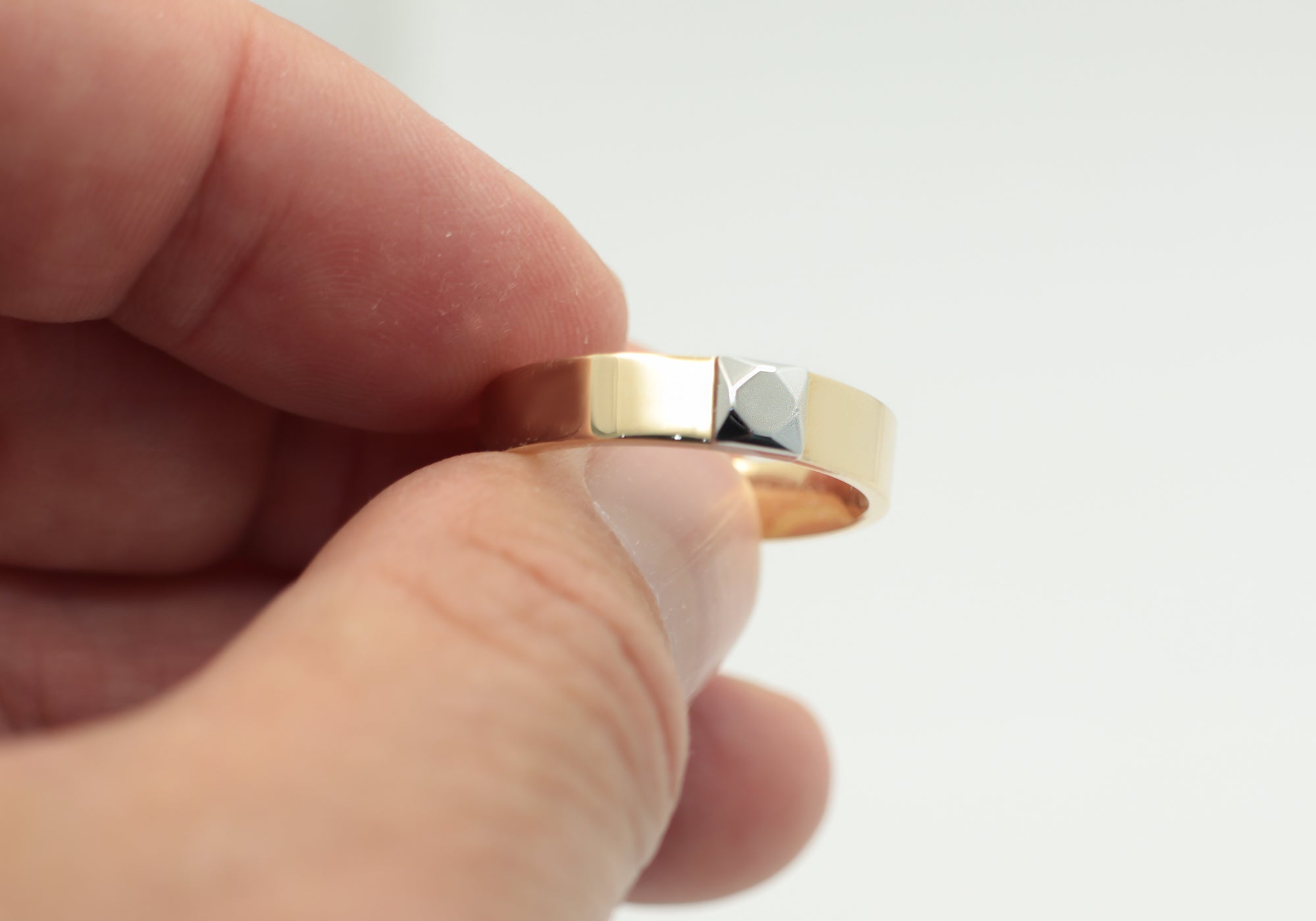 Yellow gold band with gold made faceted stone.
