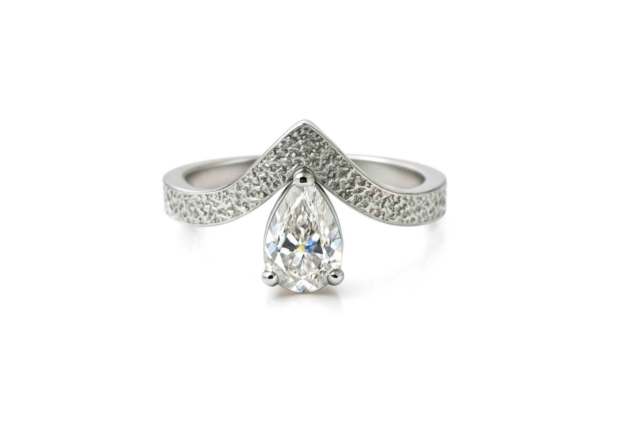 Textured V-shaped ring with pear-shaped moissanite.
