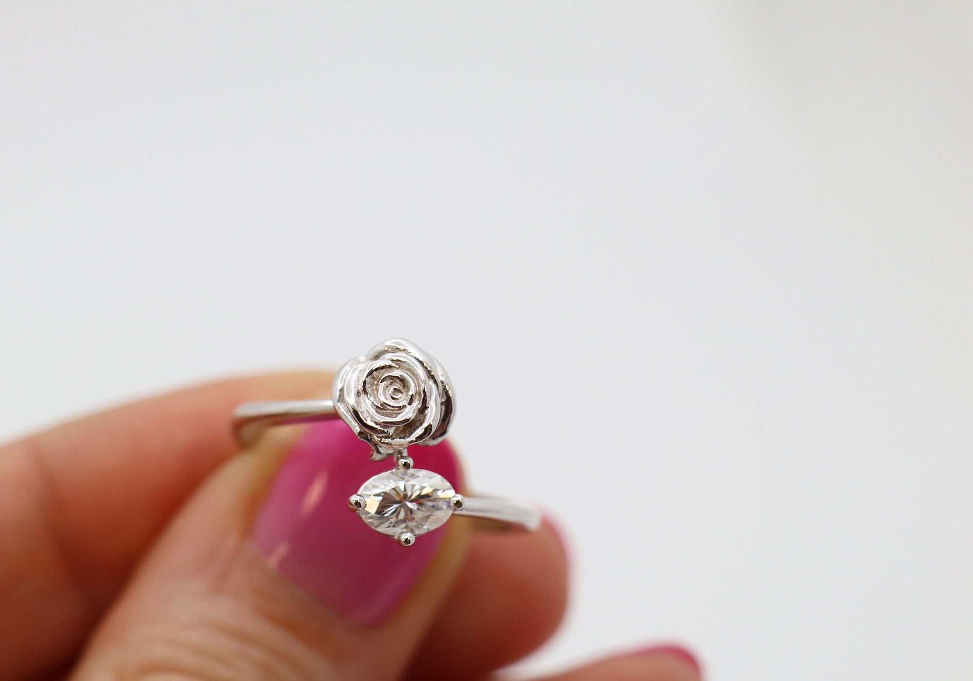 Romantic ring with a rose and a moissanite