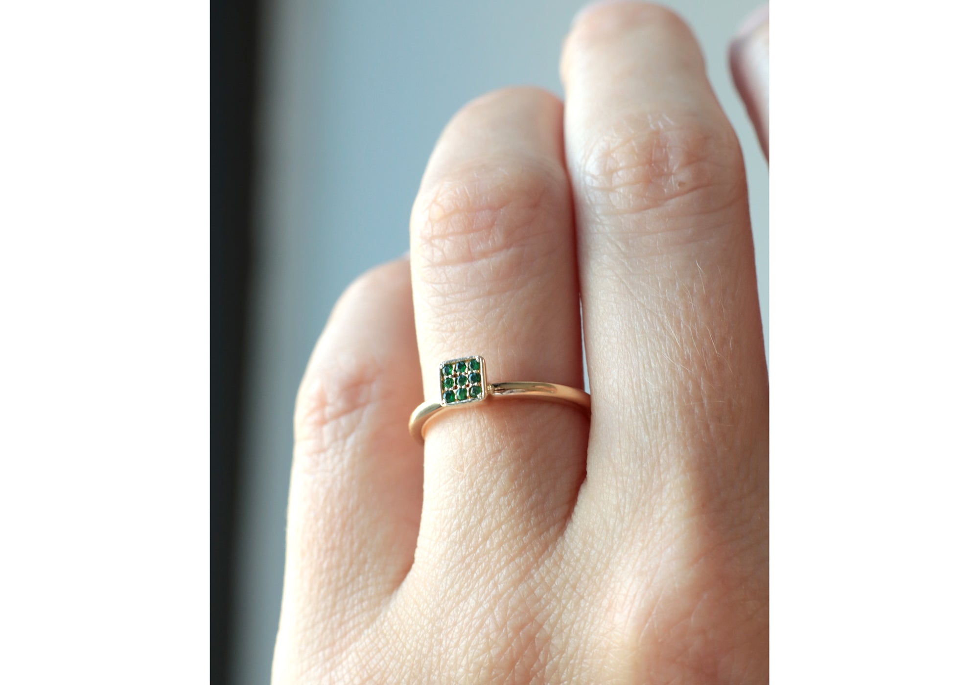 Square solitaire with pave of tsavorite garnets