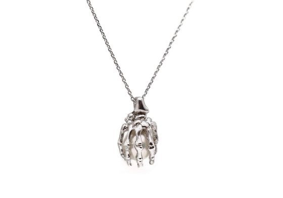 Skeleton hand pendant with white pearl